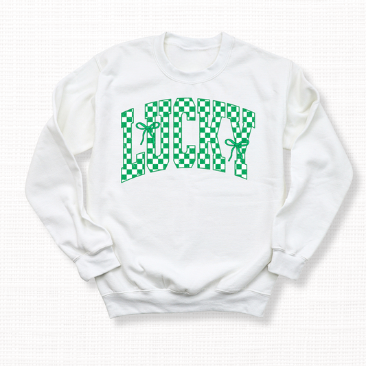 White crewneck sweatshirt with green and white checkered “Lucky” lettering and ribbon bows