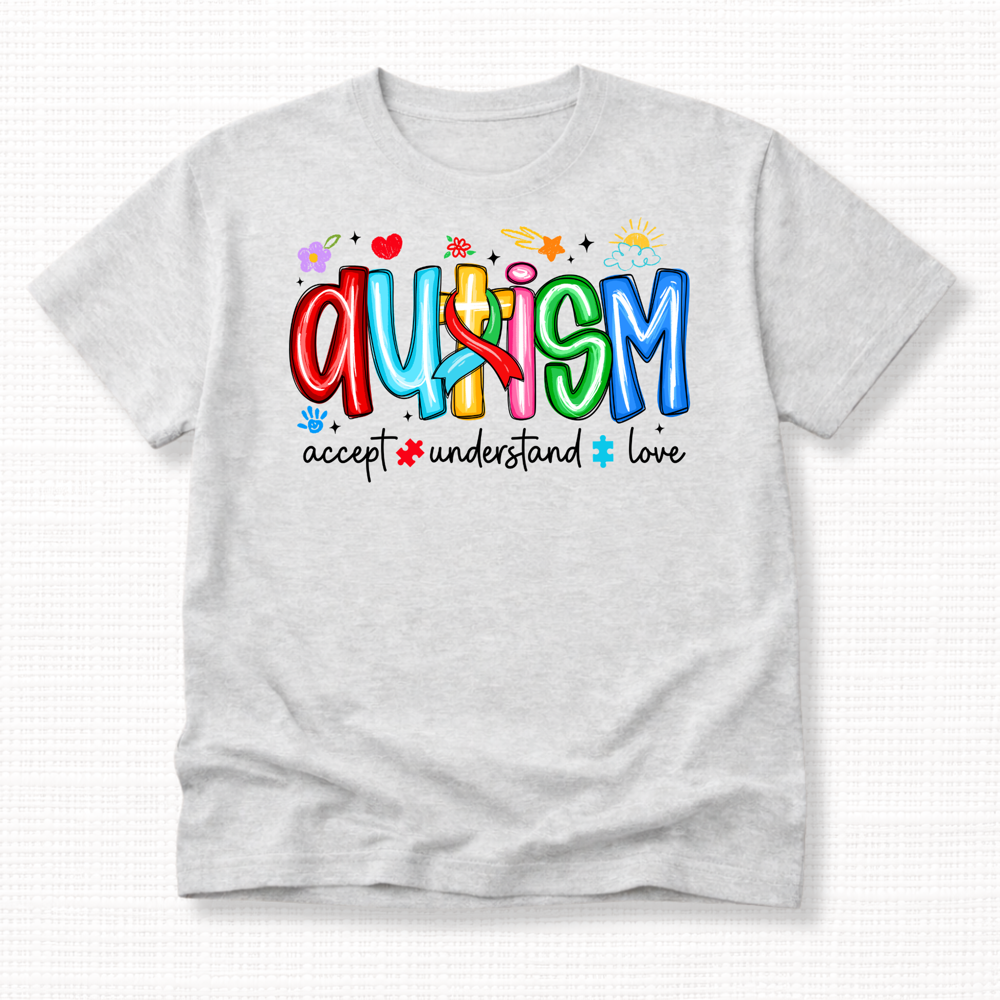 An ash grey shirt with colorful 'Autism' text and words 'Accept, Understand, Love' underneath in white.