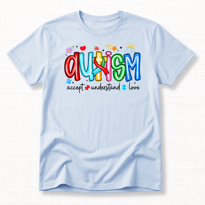 A light blue shirt with colorful 'Autism' text and words 'Accept, Understand, Love' underneath in black.