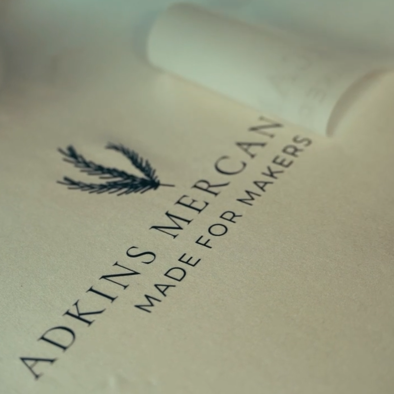 Adkins Mercantile example DTF Print that's been pressed onto a fabric and is being peeled to perfection.