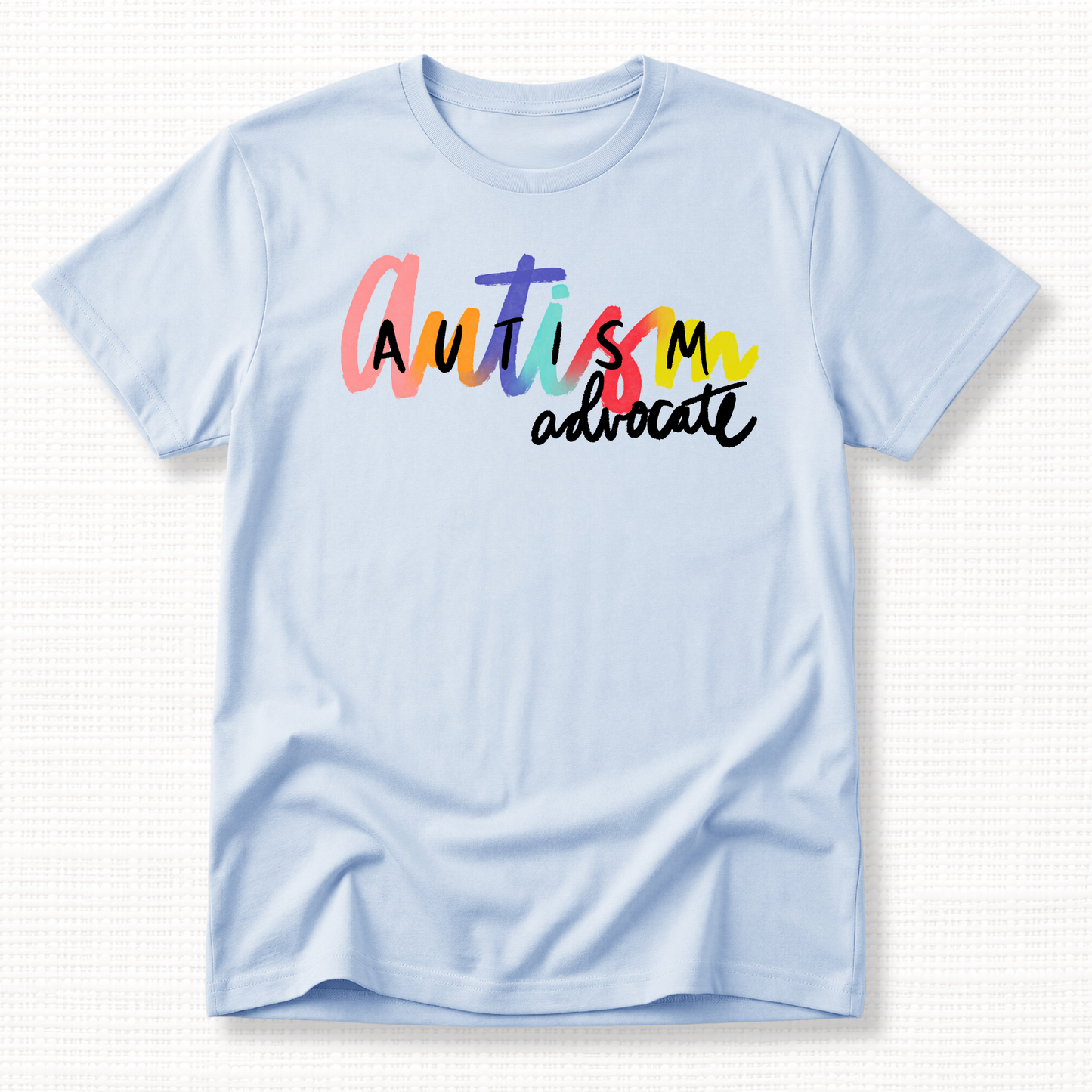 Light blue t-shirt with 'Autism advocate' text in colorful letters.