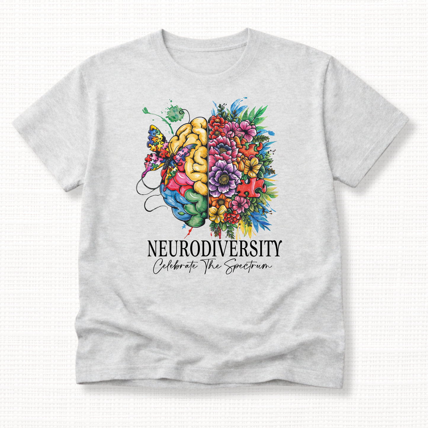 Gray t-shirt with a colorful brain and flowers design and 'Neurodiversity Celebrate The Spectrum' in black text.