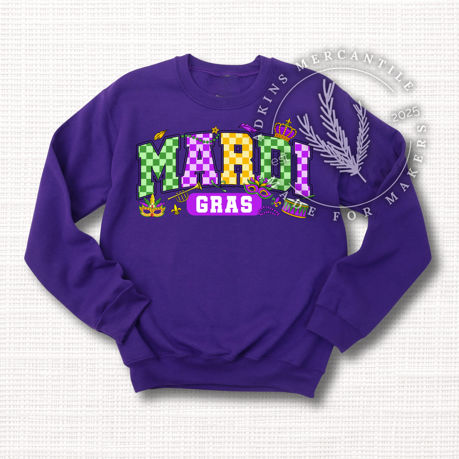 Purple crewneck sweatshirt with a Mardi Gras checkered print featuring green, gold, and purple all in the 'Mardi' text and festive symbols surrounding it.