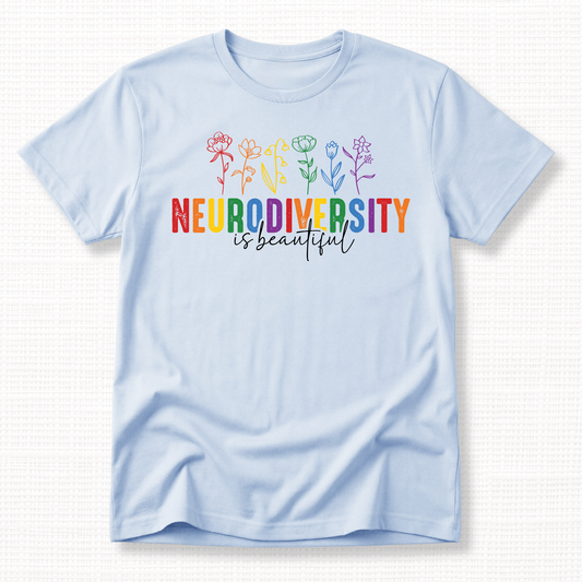 Light blue t-shirt with rainbow 'Neurodiversity is beautiful' text and colorful flowers.
